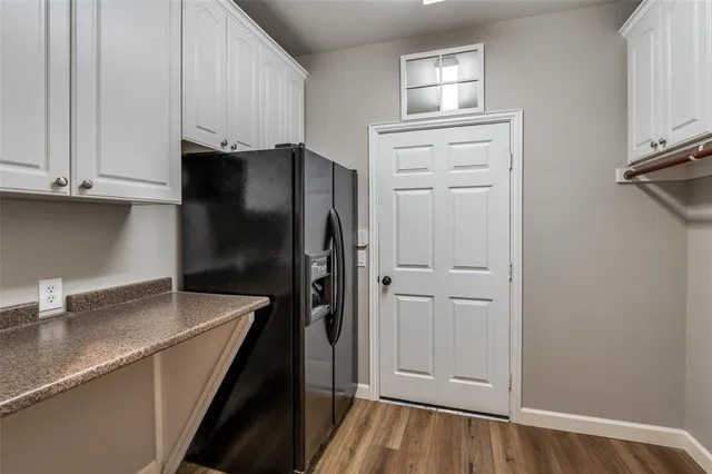 a kitchen with a refrigerator and cabinets