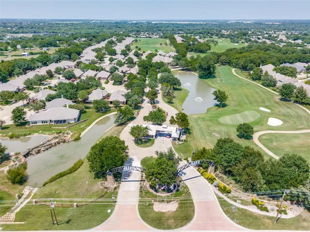 an aerial view of a house with a garden and lake view