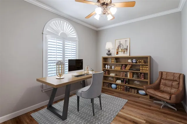 a view of a workspace with furniture and a window