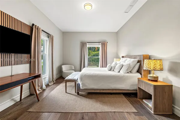 a front view of a house with yard and green space