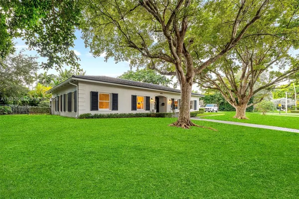 a kitchen with stainless steel appliances kitchen island granite countertop a refrigerator a sink dishwasher a dining table and chairs with wooden floor