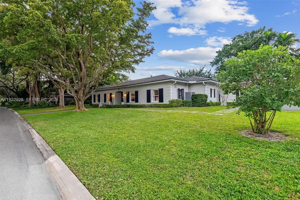 a living room with furniture chandelier and a fireplace