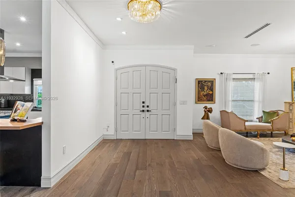 a living room with furniture and a chandelier