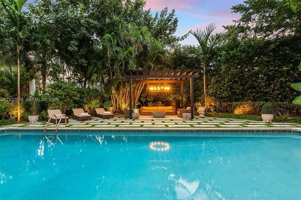a view of swimming pool with outdoor seating and yard