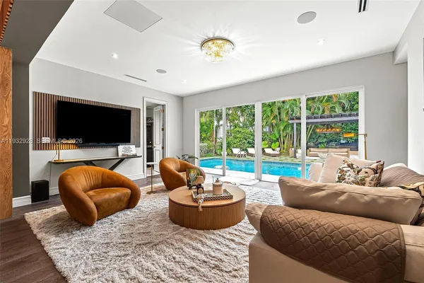a bedroom with a bed a chandelier and a window