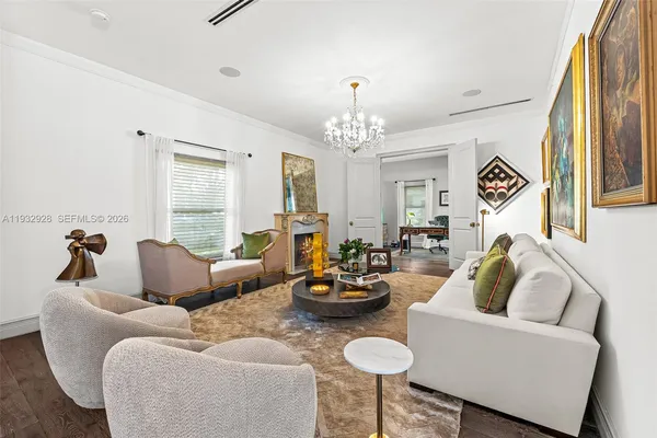 a living room with furniture and a chandelier