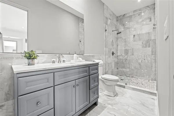 a bedroom with a bed and a night stand