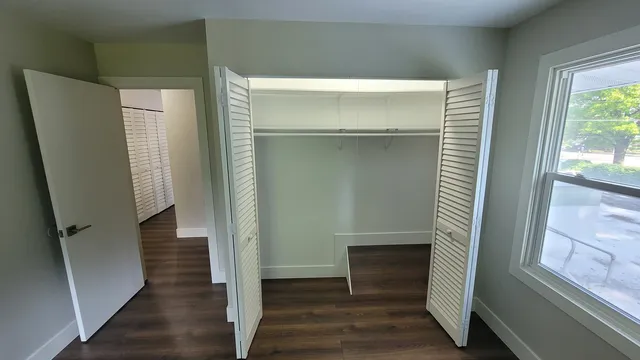 a view of entryway with wooden floor and stairs