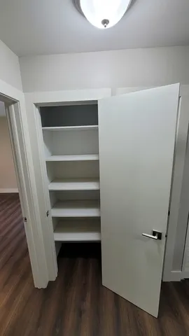 a view of walk in closet with empty racks