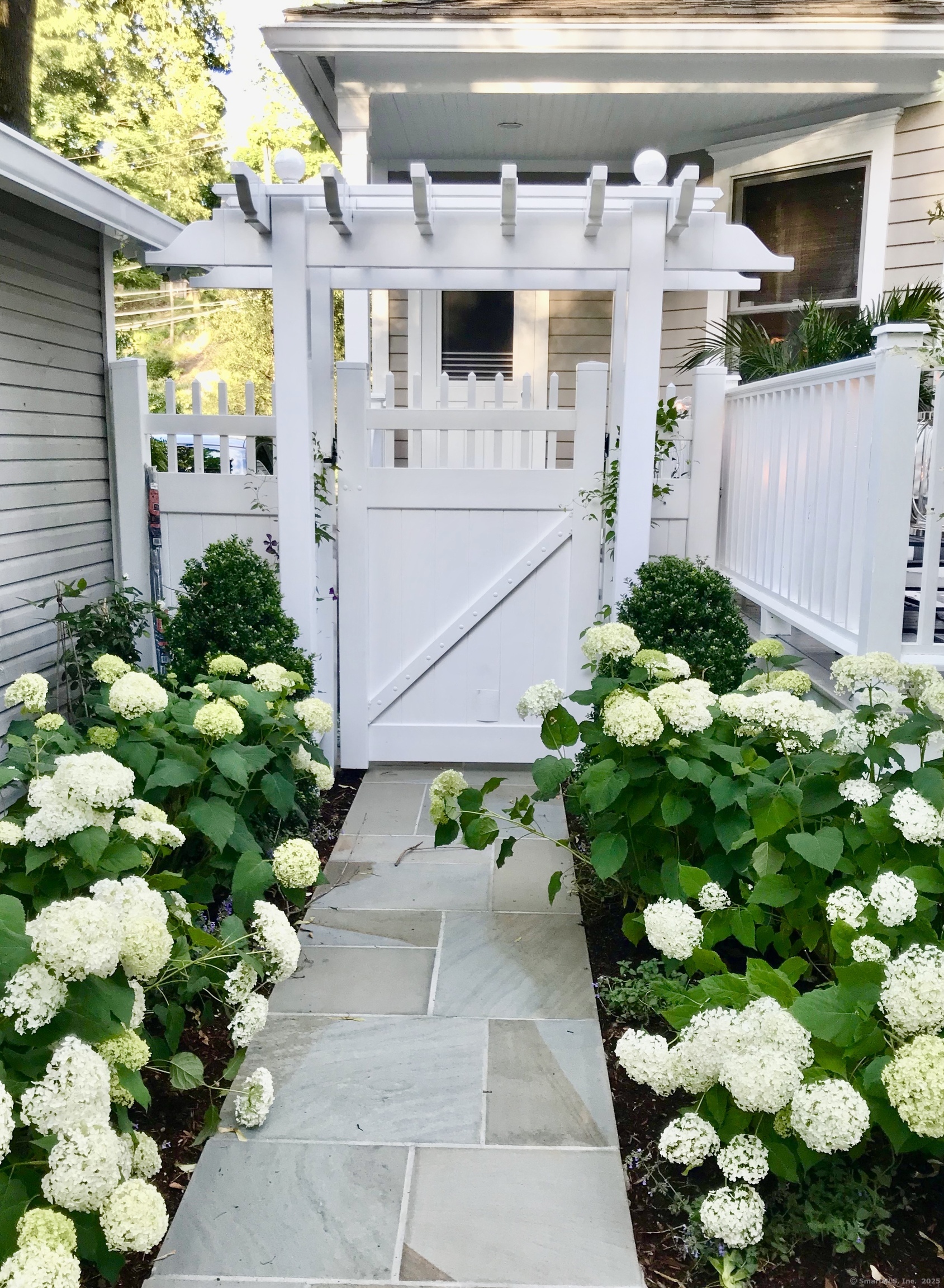 233 Rowayton Avenue Norwalk, CT 06853 - Photo 27 of 33 a white vase with white and yellow flowers