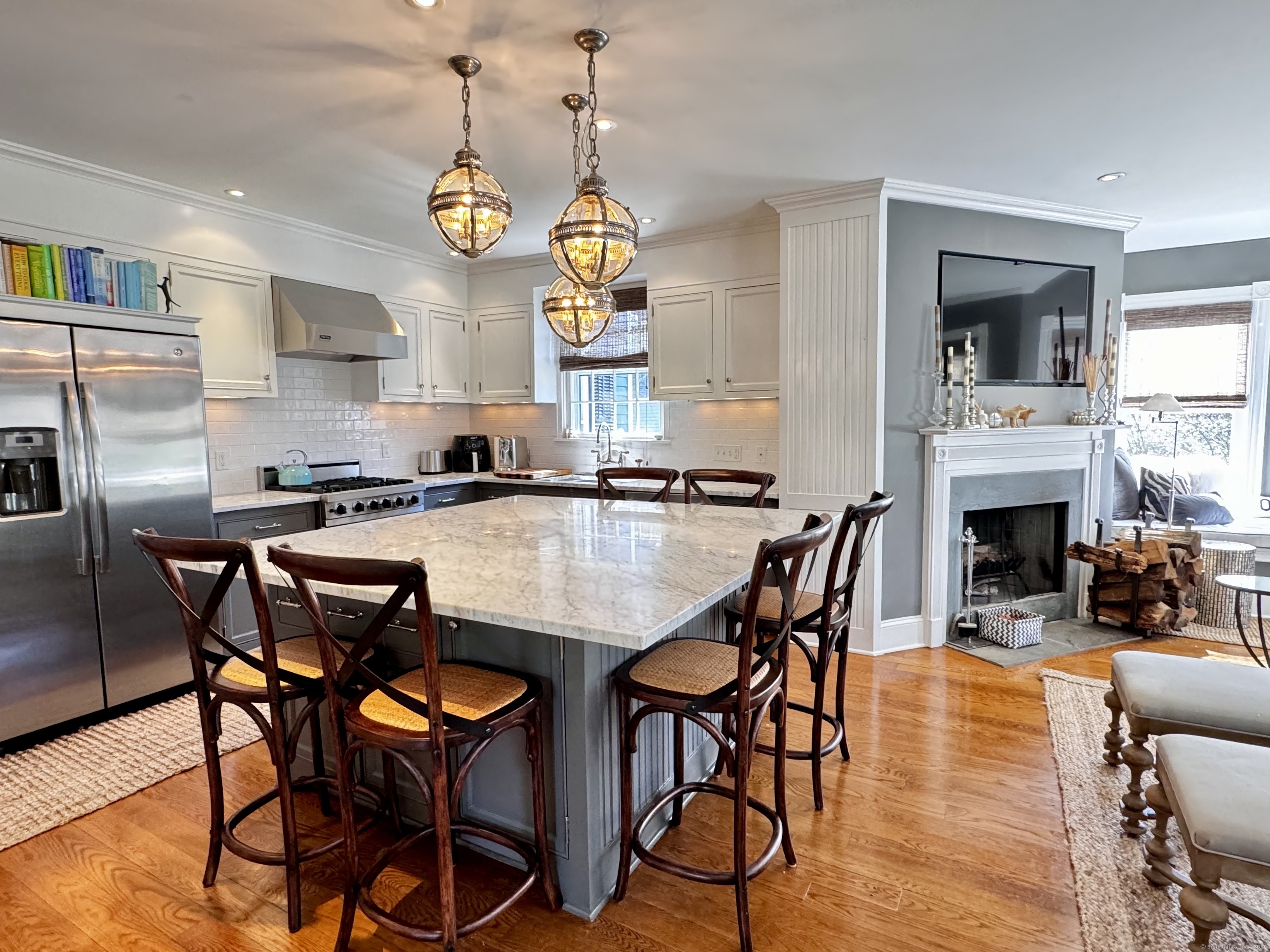 233 Rowayton Avenue Norwalk, CT 06853 - Photo 7 of 33 a dining table with chairs and fireplace