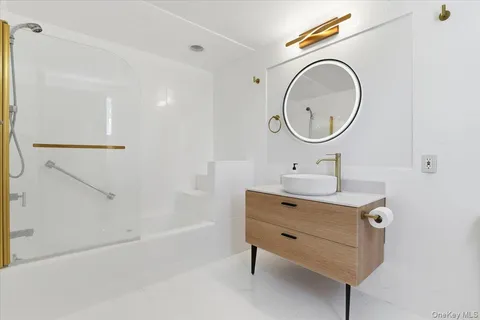 a bathroom with a sink a toilet and a mirror