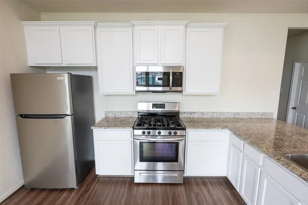 a kitchen with a refrigerator stove and microwave