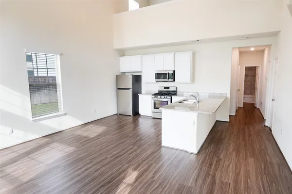 a view of kitchen with sink and wooden floor