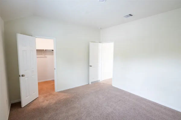 a view of an empty room and closet area