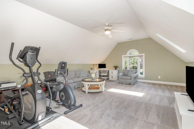 a living room with furniture a chandelier and a window