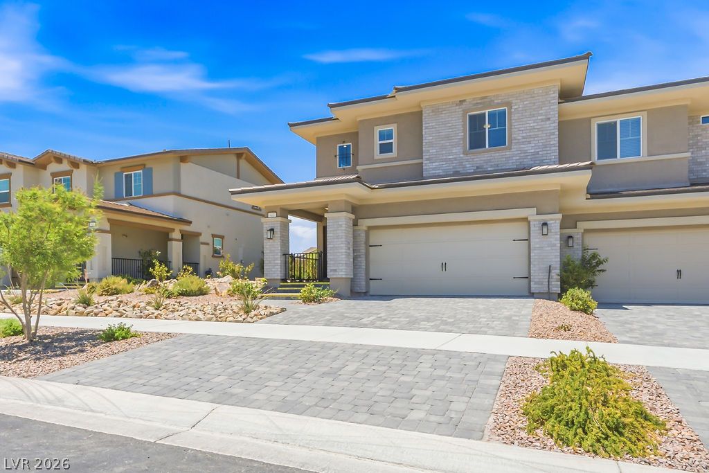 913 Cadence View Way Henderson, NV 89011 - Photo 5 of 46 Contemporary facades and integrated garages define these residences, set within a meticulously landscaped community.