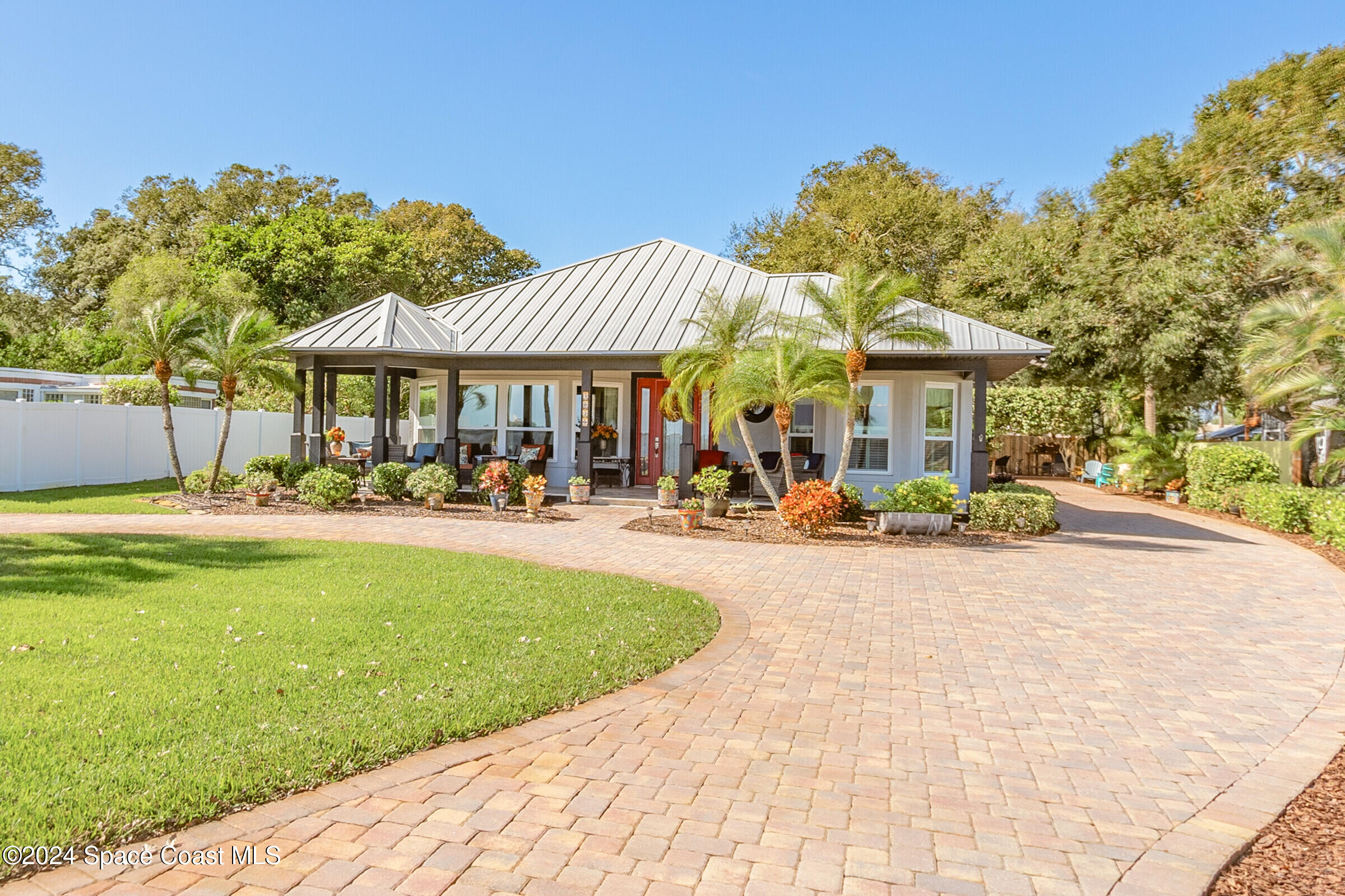 a swimming pool view with a seating space and a garden view