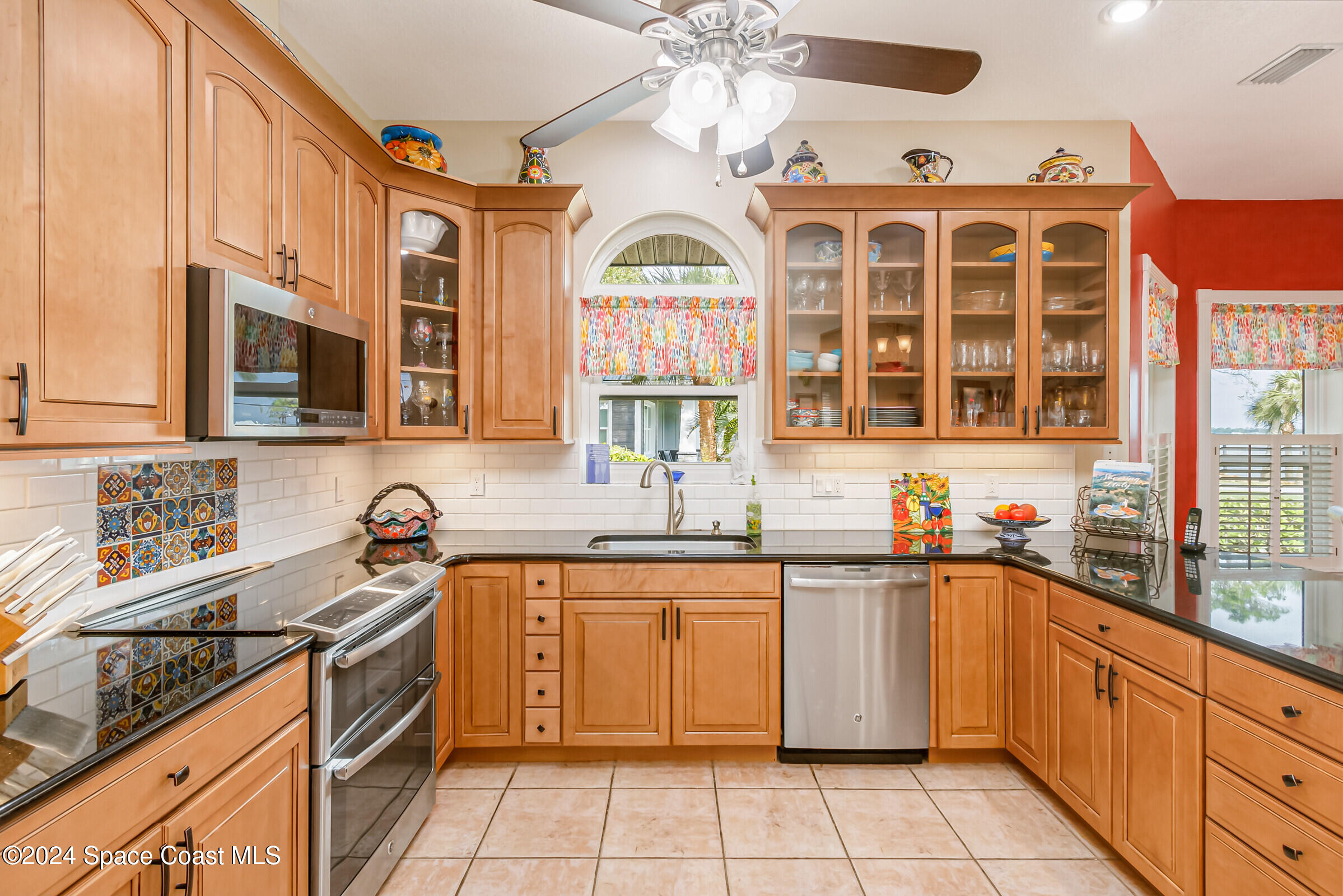 1829 Rockledge Drive Rockledge, FL 32955 - Photo 15 of 53 a kitchen with a sink stove top oven and cabinets