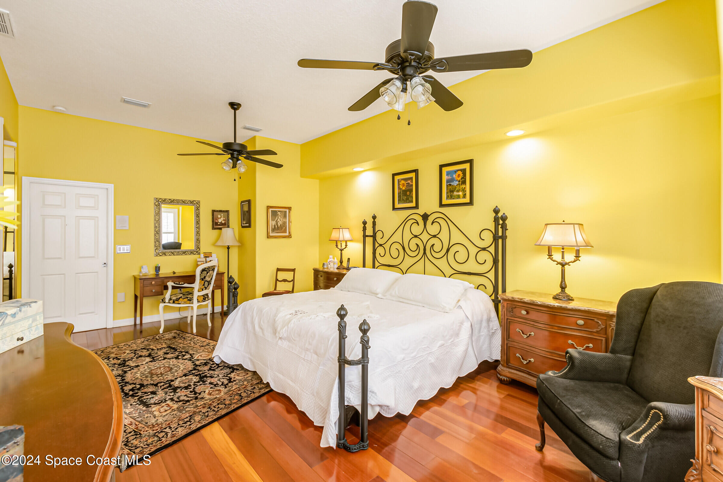 1829 Rockledge Drive Rockledge, FL 32955 - Photo 18 of 53 a bedroom with a bed ceiling fan and a wooden floor