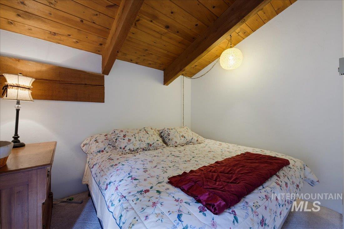 3800 Warren Wagon Road McCall, ID 83638 - Photo 27 of 50 Sloped ceiling with exposed wood beams and light wood-finish planking