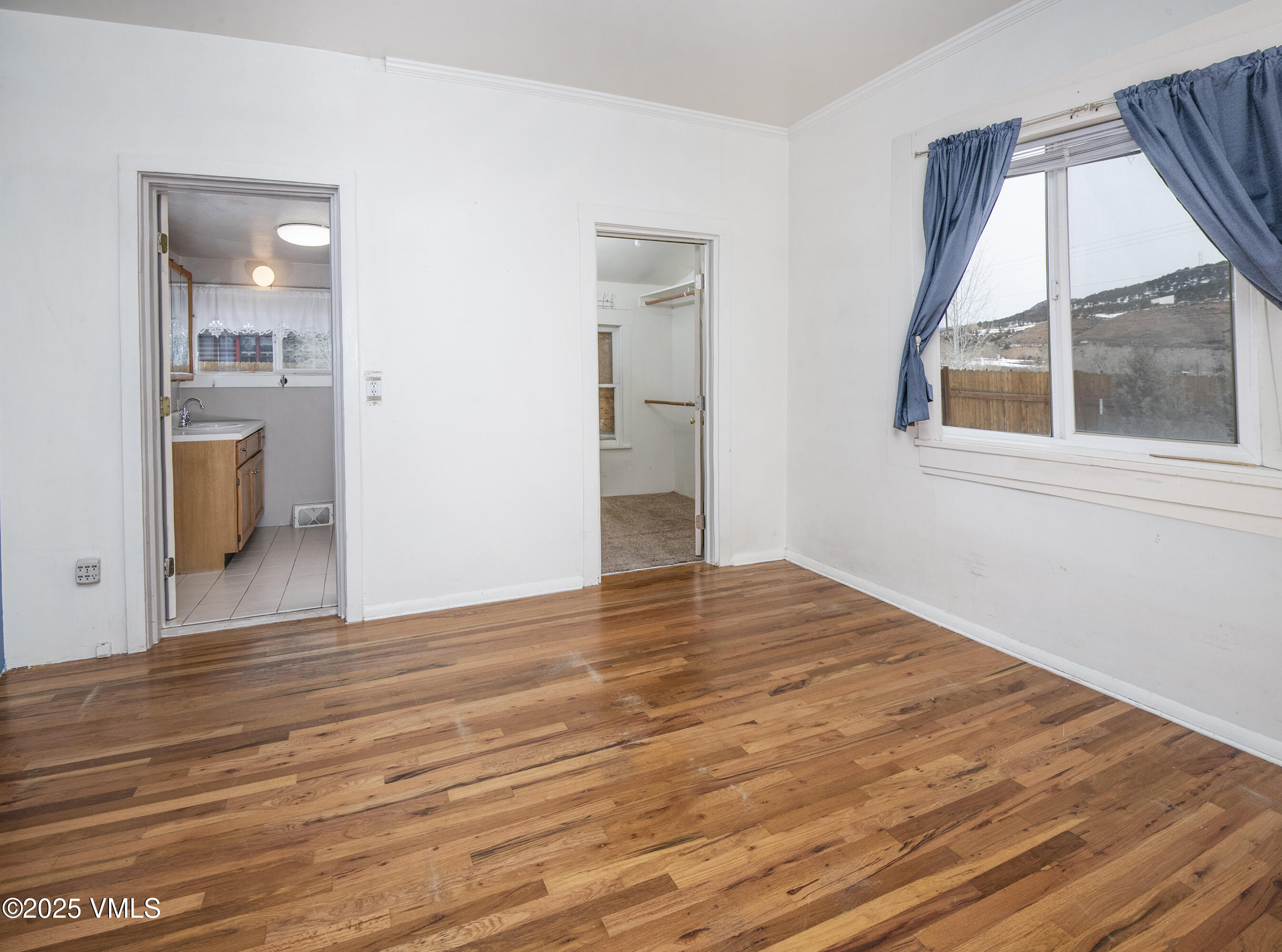 432 West 5th Street Eagle, CO 81631 - Photo 13 of 27 a view of an empty room with wooden floor and a window