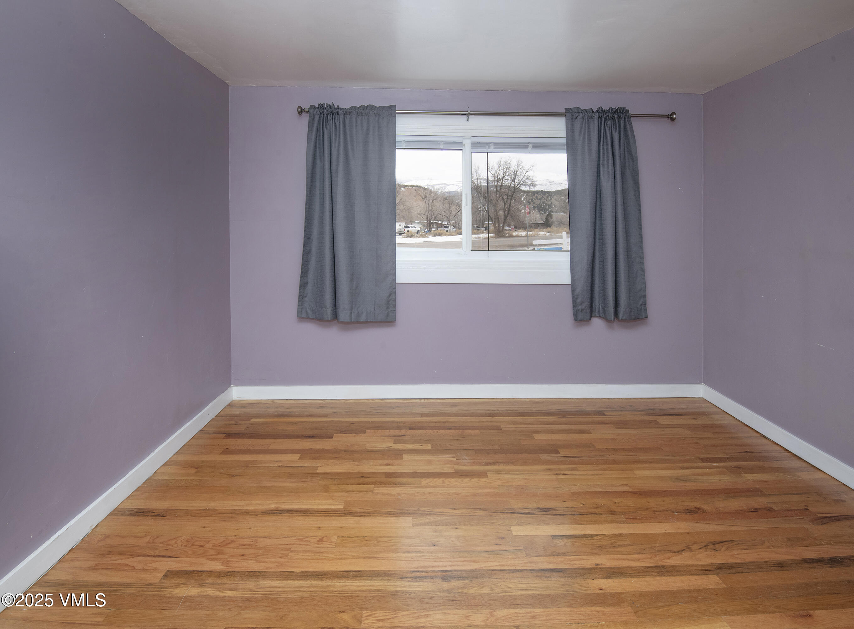 432 West 5th Street Eagle, CO 81631 - Photo 16 of 27 a view of an empty room with wooden floor and a window