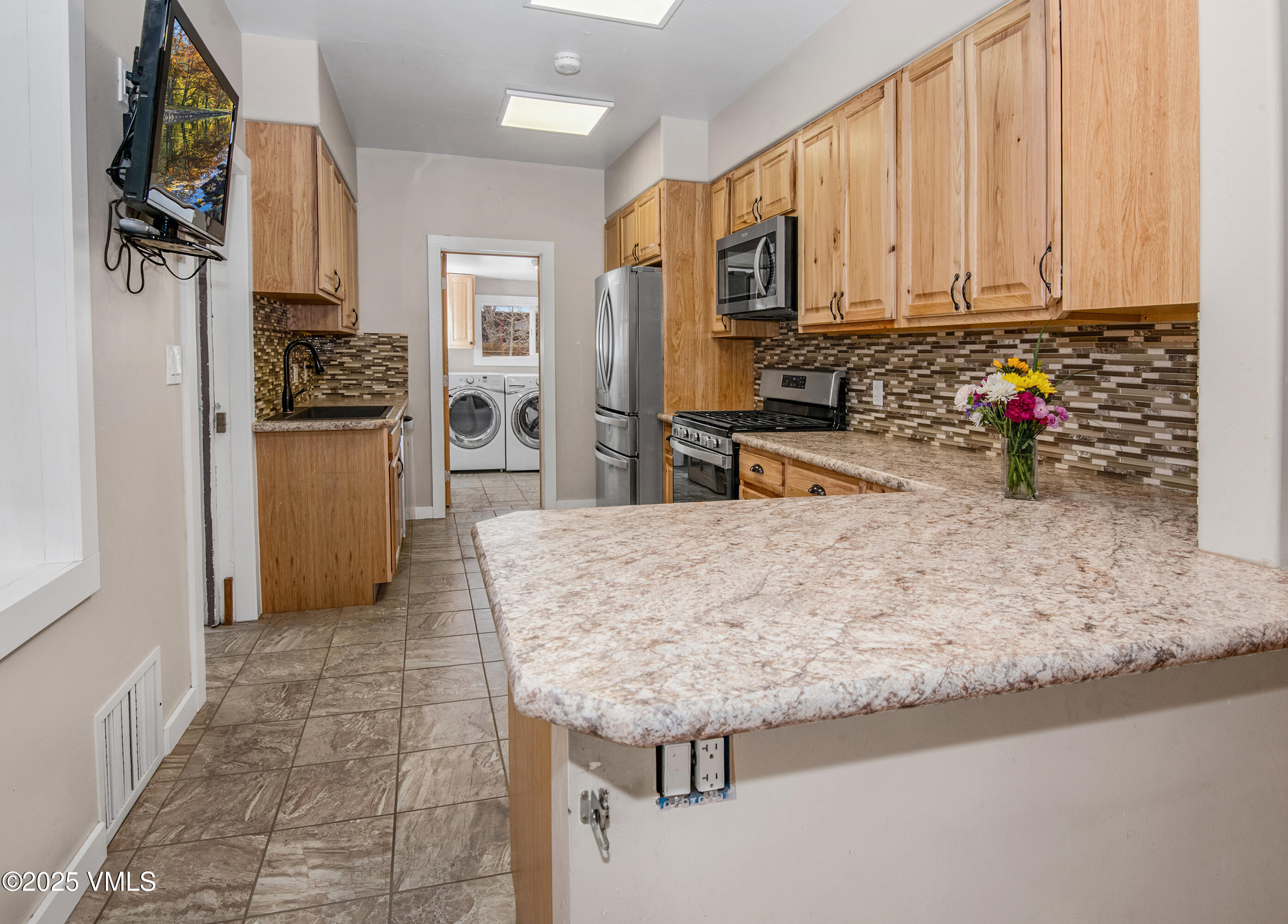 432 West 5th Street Eagle, CO 81631 - Photo 2 of 27 a kitchen with stainless steel appliances granite countertop a refrigerator sink and cabinets