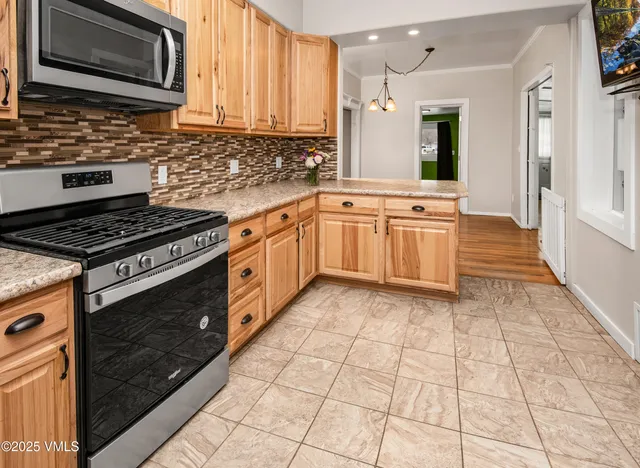 a view of kitchen with sink and refrigerator