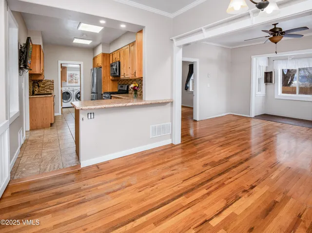 a view of kitchen with cabinets and wooden floor