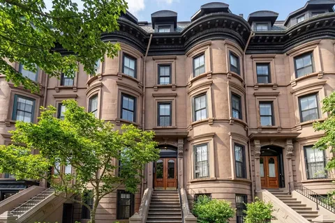 a front view of a residential apartment building with a yard
