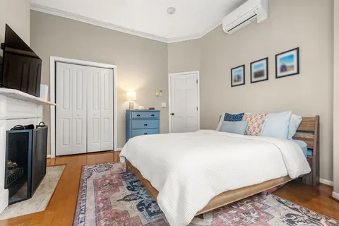 a bedroom with a bed and a television