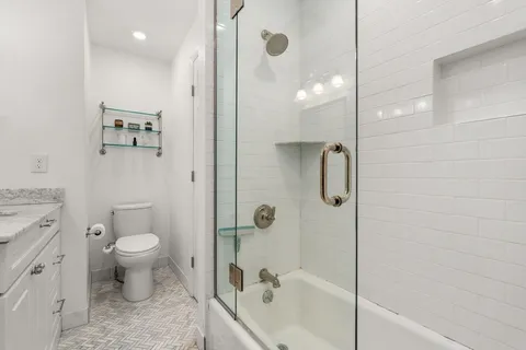 a bathroom with a shower a toilet and a shower