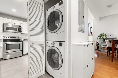 a view of a hallway with washer and dryer