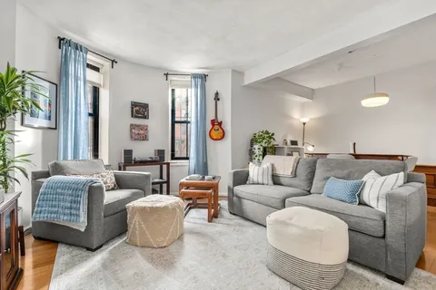 a living room with furniture and a large window