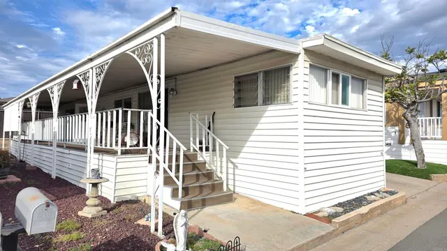 a view of a house with a chairs in patio