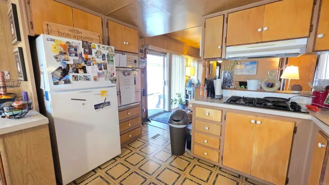 a kitchen with a refrigerator and a stove