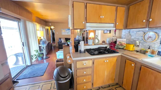 a kitchen with stainless steel appliances a stove a sink and a refrigerator