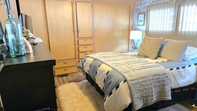 a bed sitting in a bedroom next to a window