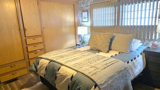 a bed sitting in a bedroom next to a window