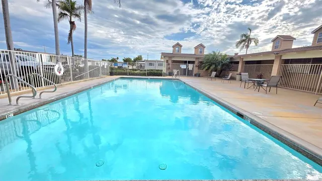 a swimming pool with outdoor seating and yard