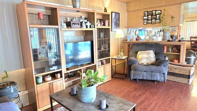 a dining room with furniture and wooden floor