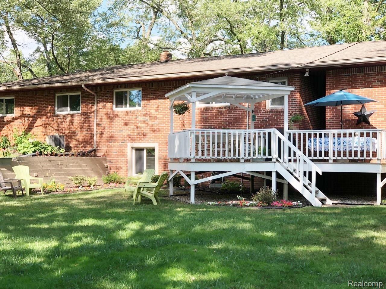 3892 South Latson Road Howell, MI 48843 - Photo 5 of 26 Enjoy relaxing on covered deck overlooking peaceful backyard.