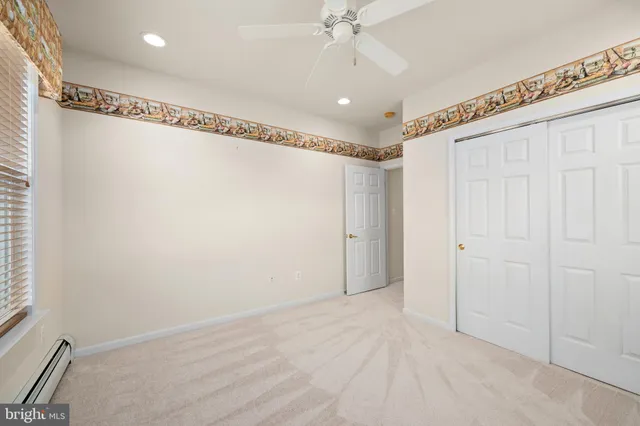 a view of a livingroom with a ceiling fan and window