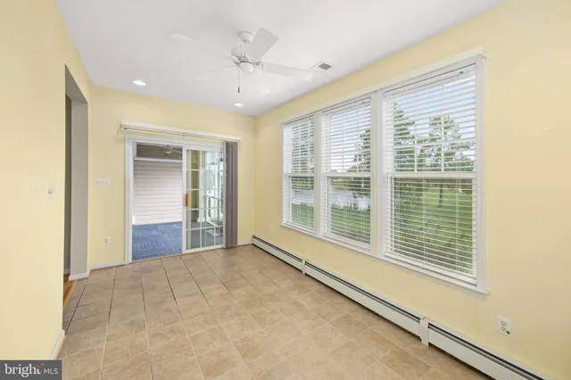 a view of a house with a big yard and large trees