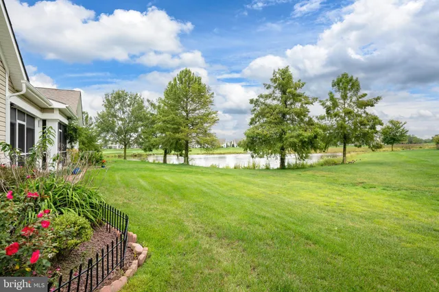 a view of a lake with houses in the back