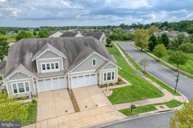 an aerial view of residential houses with outdoor space and swimming pool