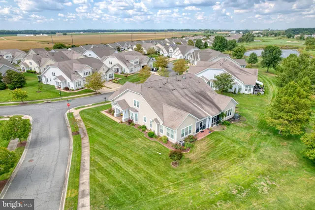 an aerial view of a house with a garden and lake view