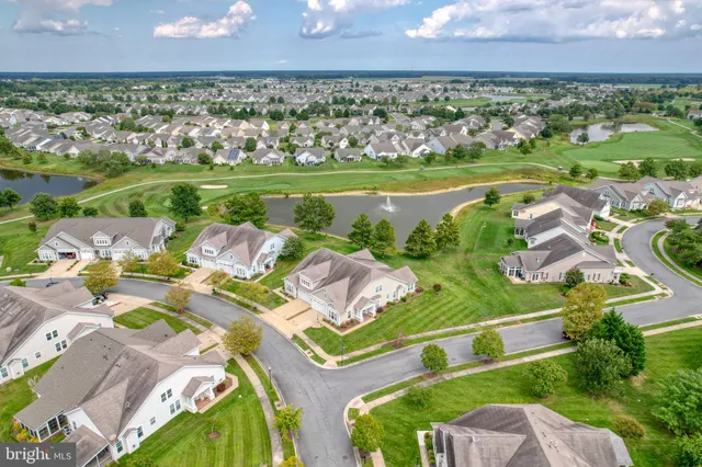 an aerial view of residential houses with outdoor space and river