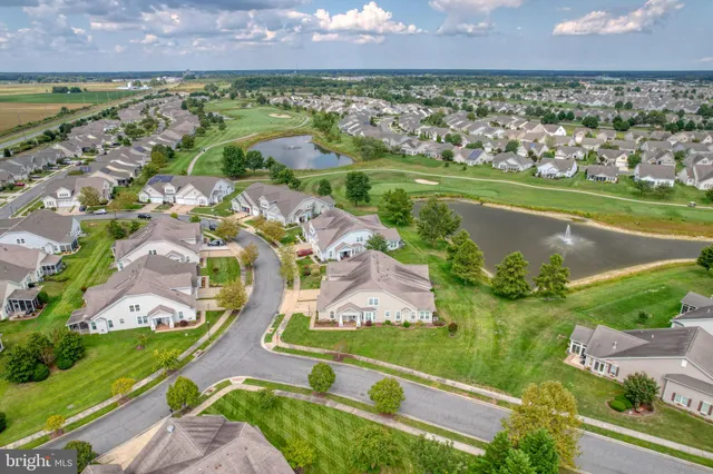 an aerial view of residential houses with outdoor space and swimming pool